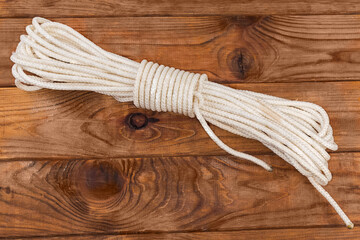 Rope bight with alpine coil knot on old wooden table