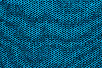 Background of knitted fabric with a pattern. Weaving winter clothes close-up.