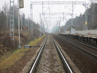 Fototapeta na wymiar railway in the village near Moscow in autumn, rails and poles with infrastructure