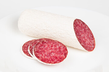 Salami sausage on a white background, close-up.