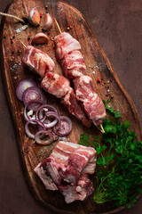 Raw pork meat, on wooden sticks, pickled kebab, with spices, top view, no people,