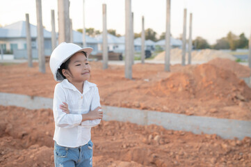 Engineer kid concept,Asian little girl wear engineer uniform working at site of building