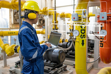 Maintenance technician at a heating plant,Petrochemical workers supervise the operation of gas and oil pipelines in the factory,Engineers put hearing protector At room with many pipes