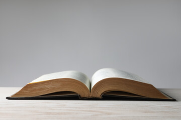 Open Bible on wooden table. Christian religious book