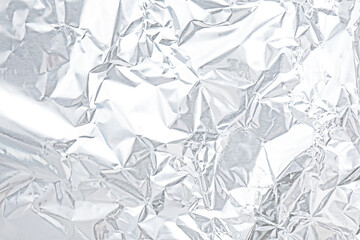 Crumpled white silver foil as background, closeup view