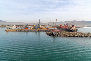 Fototapeta na wymiar View from a cruise ship of abandoned and damaged ships and boats at the port and dockyards at the Ensenada, Mexico cruise port.