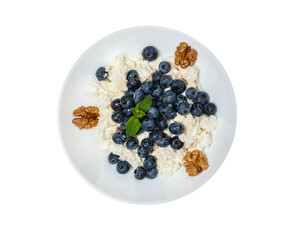 Healthy vegetarian food oatmeal with fresh blueberry nuts on isolated background top view
