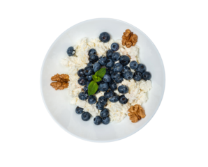 Healthy vegetarian food oatmeal with fresh blueberry nuts on isolated background top view
