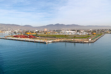 Naklejka na ściany i meble View from a cruise ship of the cruise passenger terminal, port and dockyards at the Ensenada, Mexico cruise port.