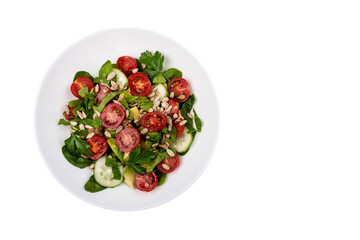 Green salad with sliced avocado tomatoes cucumbers with copy space on isolated png background