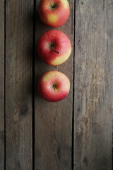 Ripe juicy apples on a wooden background.