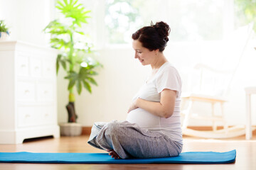 Pregnancy yoga. Exercise for pregnant woman.