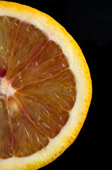 Macro Detailed Image of Blood Orange Halve on Black Background