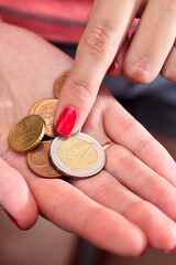 Counting coins in hand. Price increase.