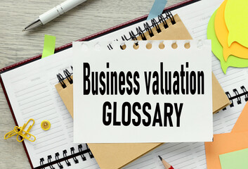 Business Valuation Glossary. text on an open notepad. on the diary.