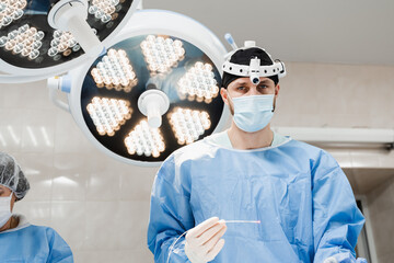 Endovenous laser coagulation for treatment varicose veins. Vascular surgeon is holding EVLT Red...