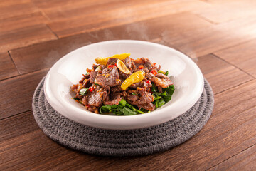 Stir-fried Yellow Beef with Coriander served dish isolated on wooden table top view of Hong Kong food
