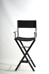 Black wooden folding chair on a white background.