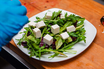 Salad of arugula and beets and pomegranate with cheese. Lots of greens for cooking.