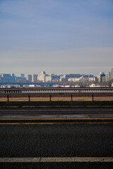 View of london skyline over blackfriars bridge with no traffic but small group of people walking past on sunny