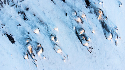 Winter Landscape in Iceland. Snow Covered Hills On The Ocean Shore. Abstract 