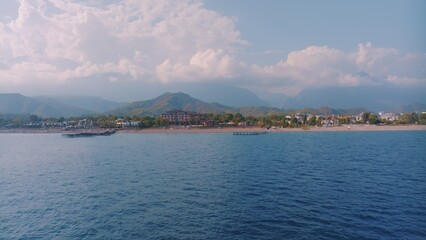 Panorama view of the blue sea. Beautiful clouds. Photography. Mountains in the background. Seascape.