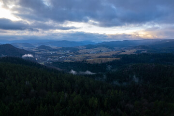 Bieszczady mountains. Cloudy sunrise in the mountains. Moody morning in the mountains. Sun through the clouds in the mountains. Sunrays in mountains.