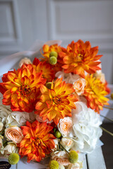 bouquet of flowers orange dahlias, beige roses
