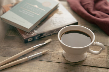 cup of coffee and books and brushes