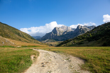 A valley in the mountains with a dirt road. A quiet and peaceful place in the mountains of the Alps...