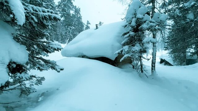 Winter landscape wooden house snowy mountain forest in snowstorm. Road for snowmobiles among snow-covered firs. Winter Russia, Siberia. High quality 4k footage
