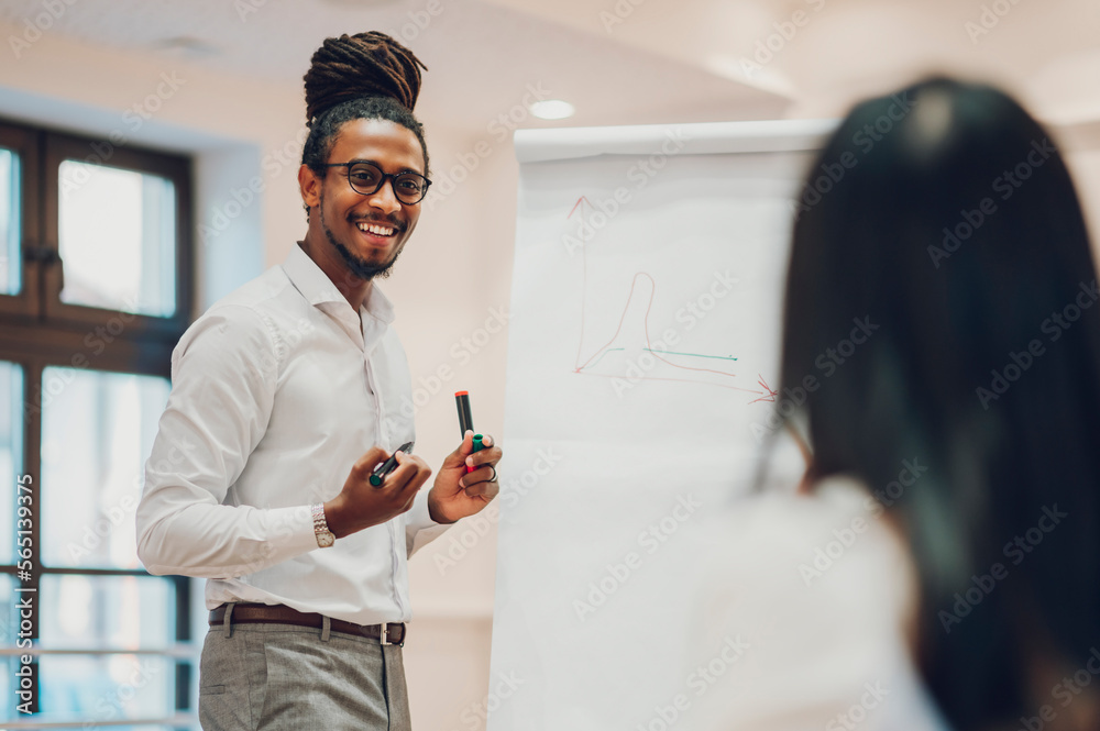 Wall mural arabic businessman holding a meeting to his diverse colleagues in an office