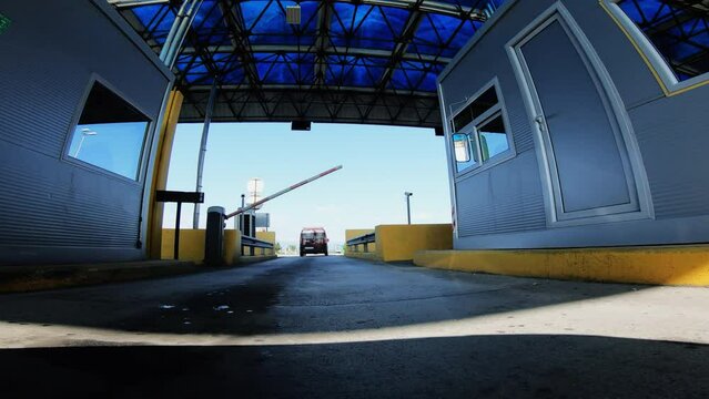 Car drive at pay toll boot, driver pay for the expressway