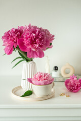 Cup with cappuccino, flowers peony, morning concept, woman's day