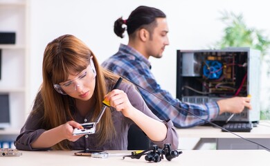 Two technicians working at computer warranty center