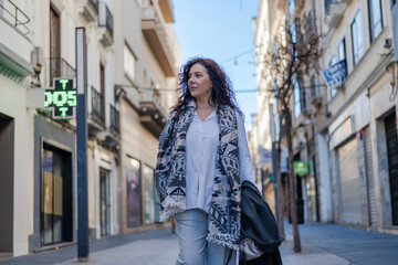 Fototapeta premium Mature Woman Walking Down Urban Street