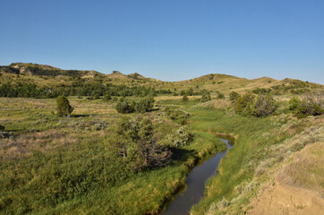 Fototapeta na wymiar Creek Meandering Through Remote Rural Landscape in the West