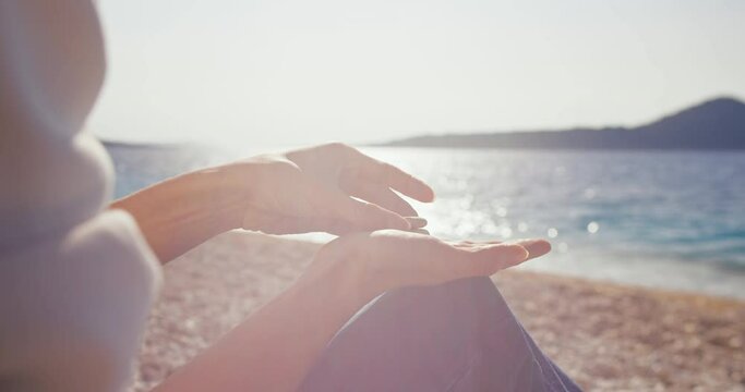 Woman Stacking Rocks On Her Hand On Beach, Stability Concept