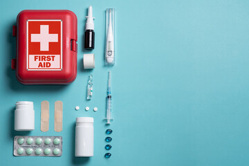 Fototapeta na wymiar Home first aid kit on a blue background. The elements of the first aid kit