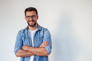 Isolated shot of young handsome man with beard, wearing casual clothes, posing in studio on white background