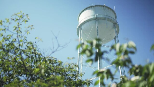Water Tower Rack Focus from Plants in Foreground