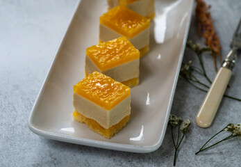 tangerine cupcakes on rectangular white cloth plate with gray background, horizontal image,