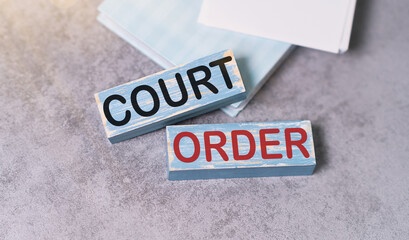 Court Order text on wooden Block on Grey Background.