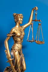golden lady justice on blue background