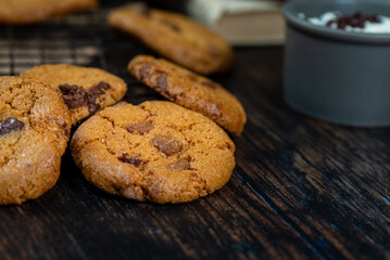 handmade gluten-free cookies, dark background on baking rack, books in the background.