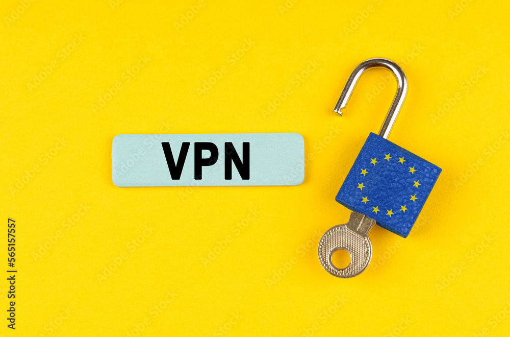 Poster on the yellow surface is an open lock with a key and a sticker with the inscription - vpn