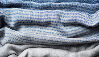 Background with draped blue gray cotton fabric, napkin, striped tablecloth or scarf, soft focus