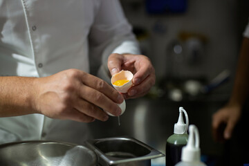 Obraz na płótnie Canvas Cook breaking eggs. egg yolk