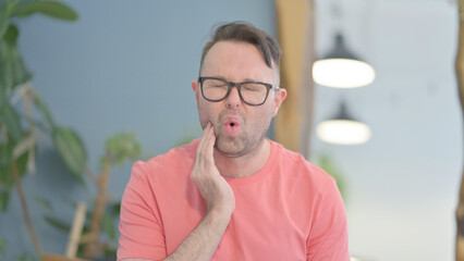 Portrait of Man having Toothache at Work