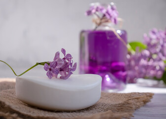 Fototapeta na wymiar Toilet soap, lilac flower on a light background